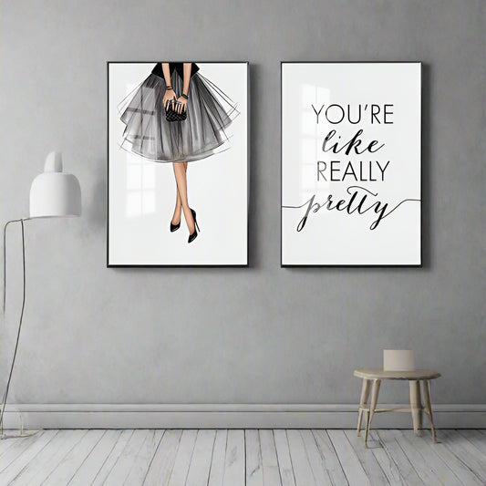 Two framed artworks on a gray wall with a minimalistic interior design.